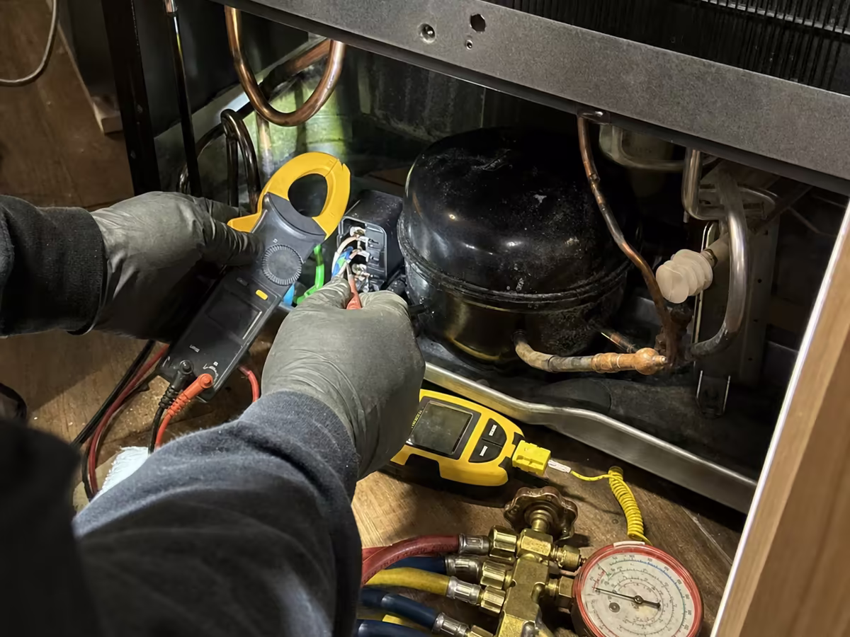 Refrigeration manifold gauges connected to a Sub-Zero sealed system during diagnosis