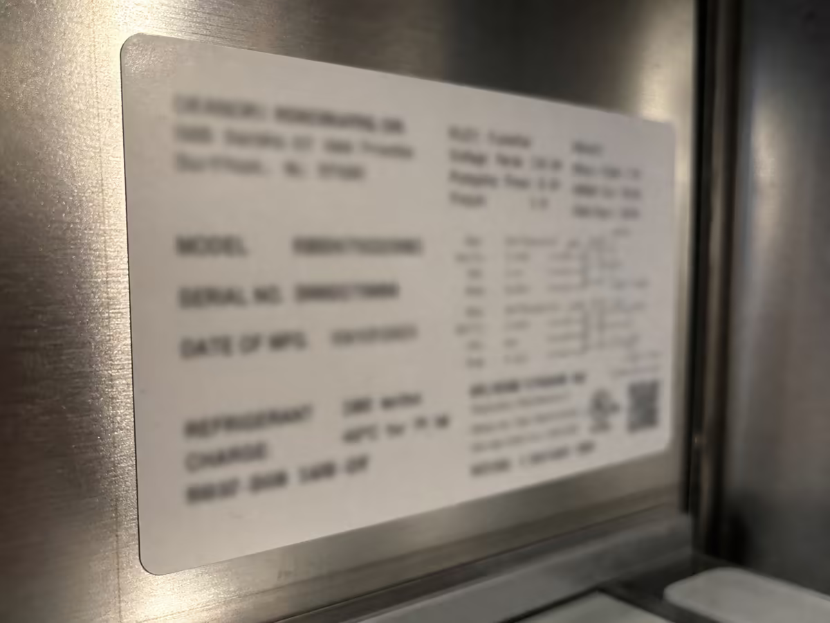 Sub-Zero model and serial tag photographed to interpret an alarm code