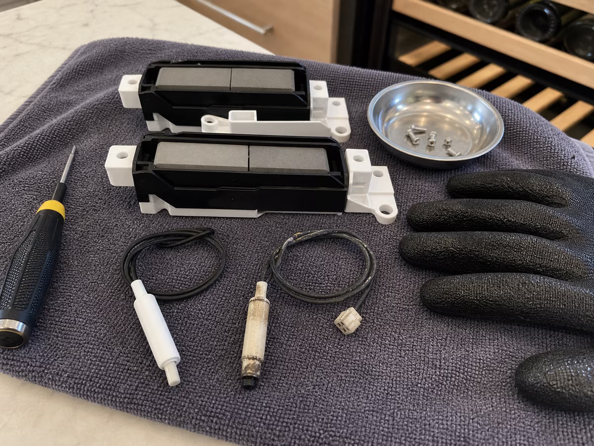 OEM Sub-Zero wine column thermistor and damper parts laid out before installation